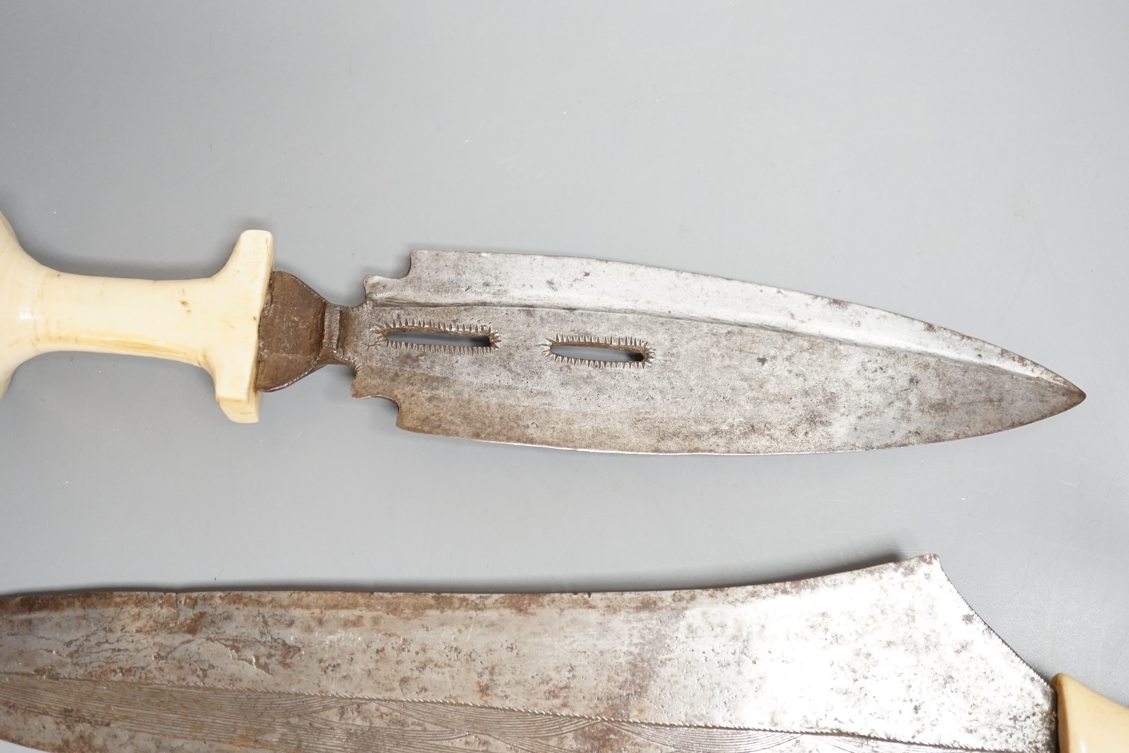 Three assorted African tribal daggers c.1900, each with ivory handle including two with decorated blades and one with iron pommel, maximum 40cms